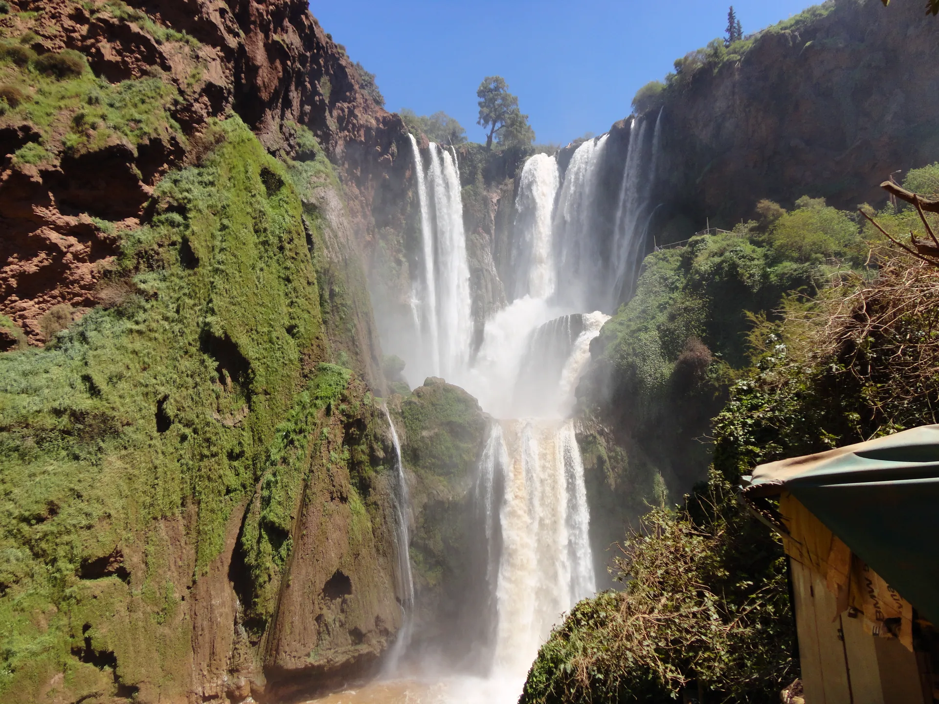 The 110-metre Ouzoud Waterfalls cascading over red rock terraces in the Middle Atlas, Morocco